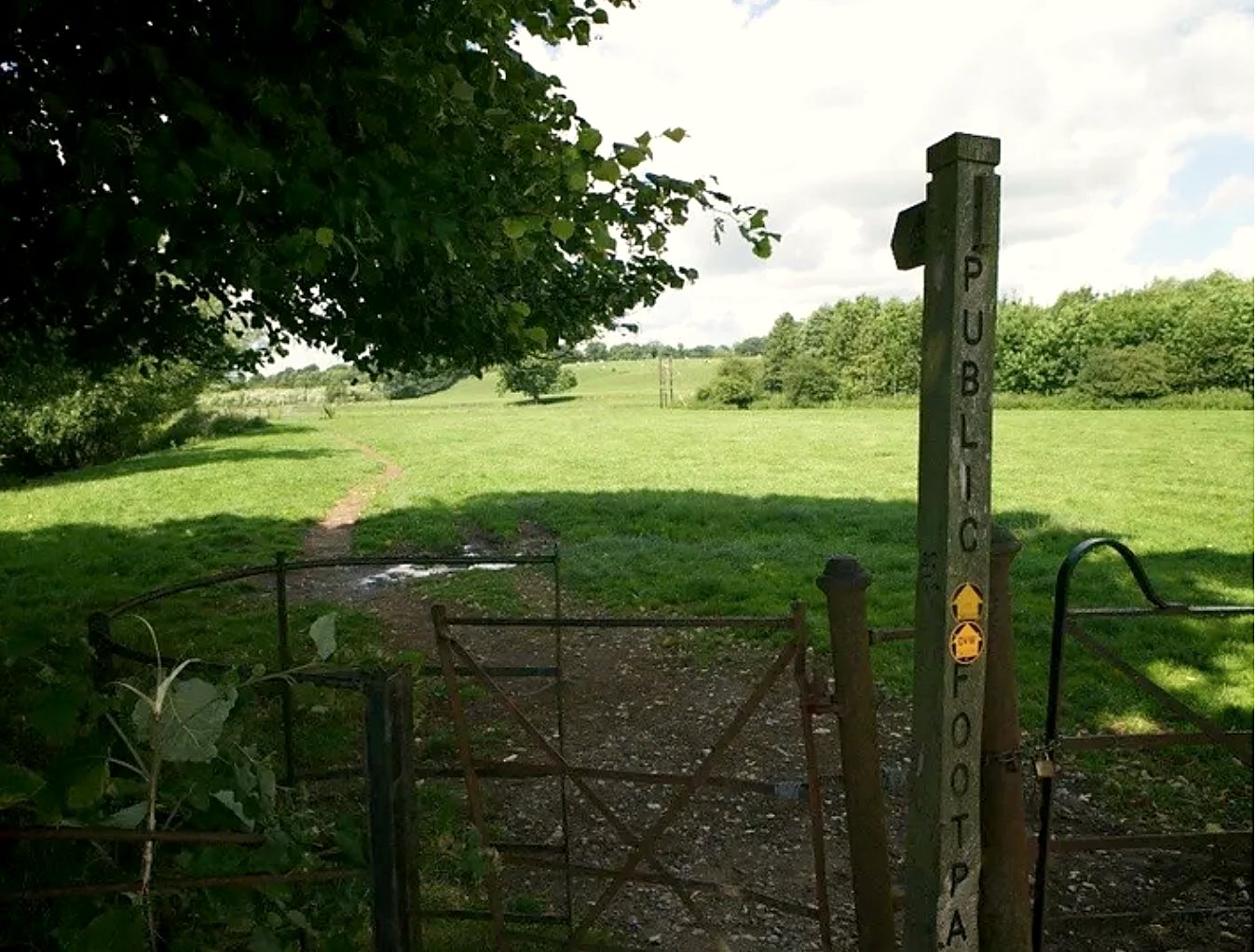 Public footpath gate leading into open green fields